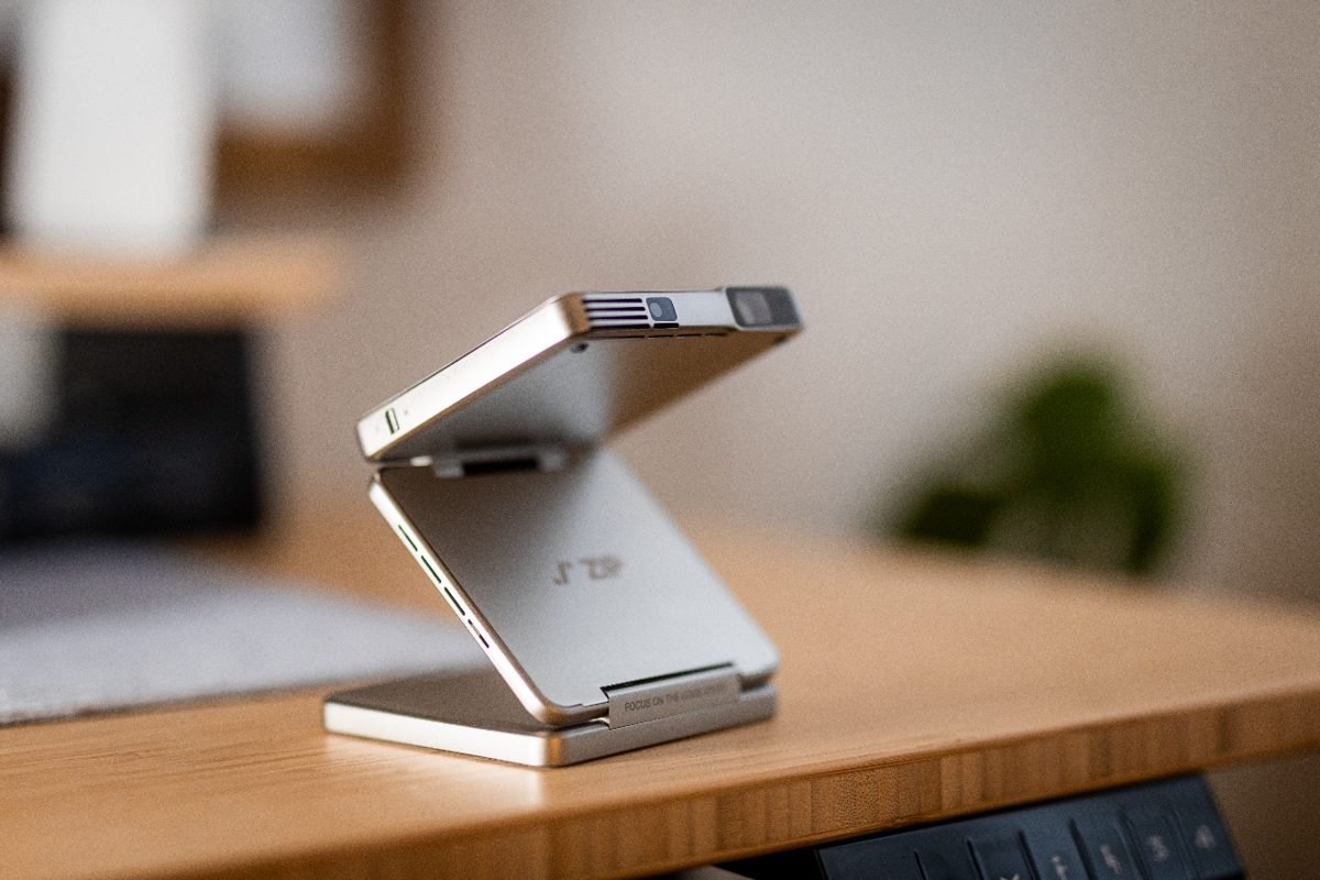 The ZIP folding stand on a wooden desk in soft light