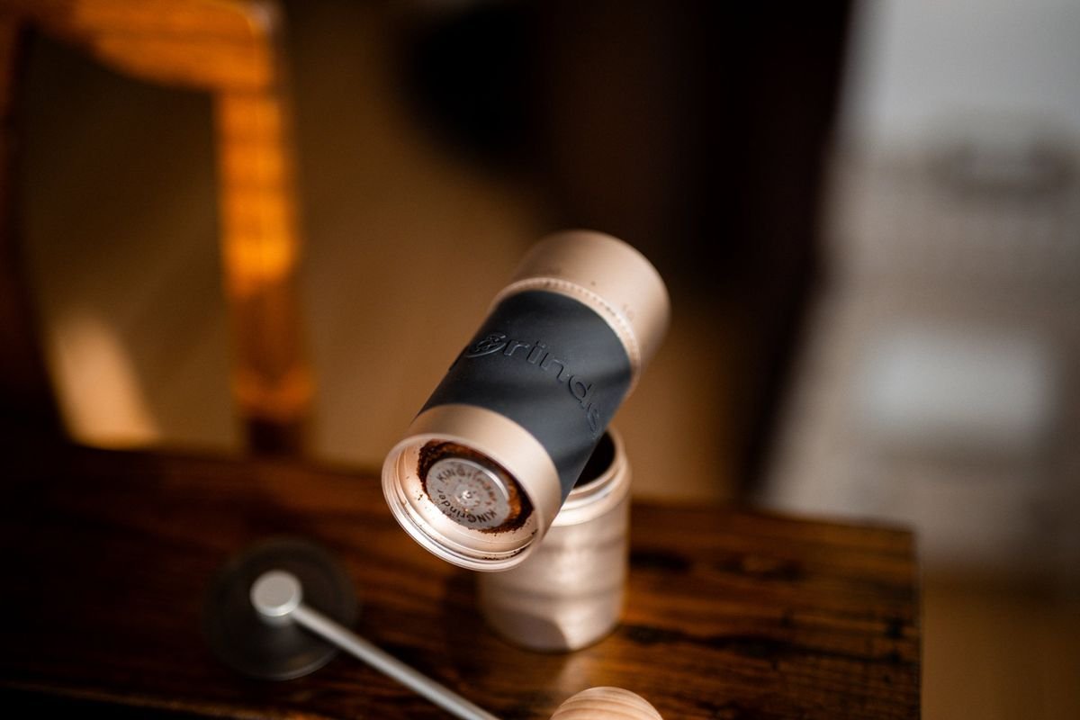 The K6 tipped toward the camera, grounds on the burr and the catch cup below